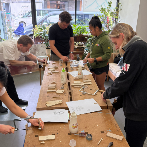Group woodworking together during the Dog Lamp Workshop.