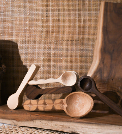 Finished hand-carved wooden spoons displayed on a table, showing the final result of the Spoon Carving Kit activity.